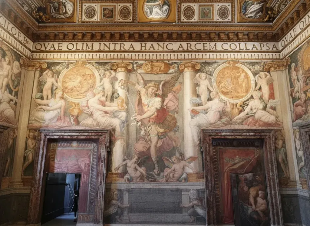 A large, ornate fresco of the Archangel Michael with a sword in the Papal Apartments at Castel Sant Angelo